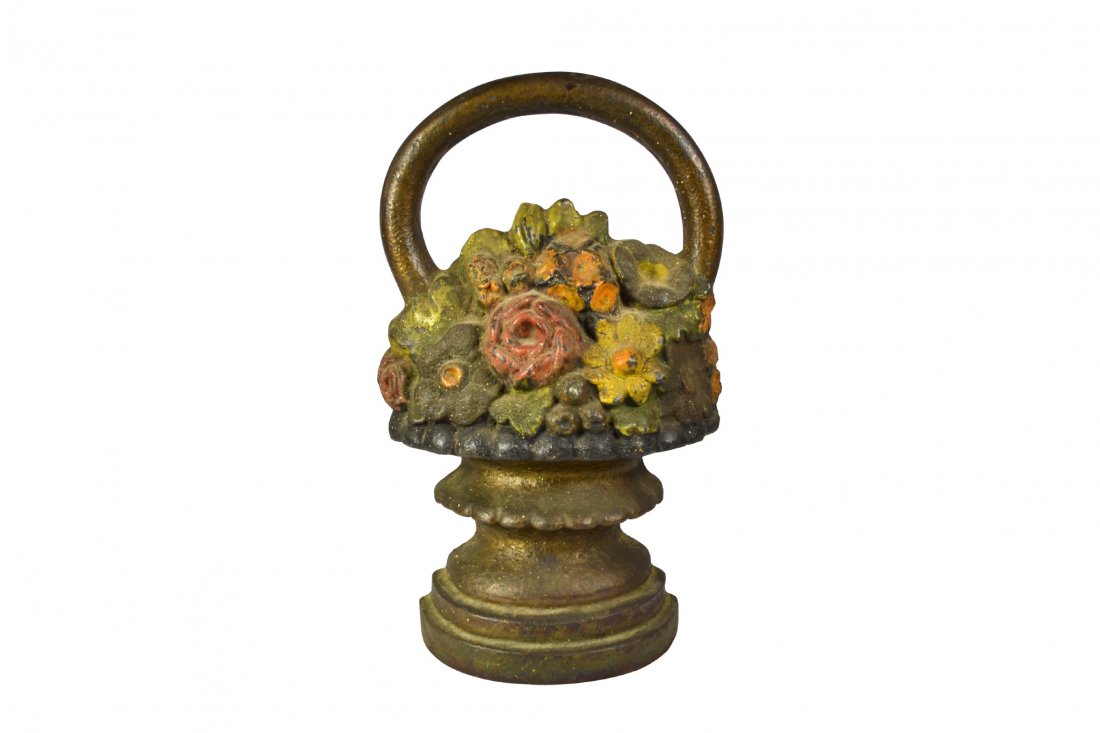 Doorstop, Floral with three-tier basket: Doorstop, Floral with three-tier basket Door stop Form: Basket of flowers Material: Cast iron Marks: None Colors: Red, yellow, orange, green,black, bronze Features: Three tier basket with flowers. Per