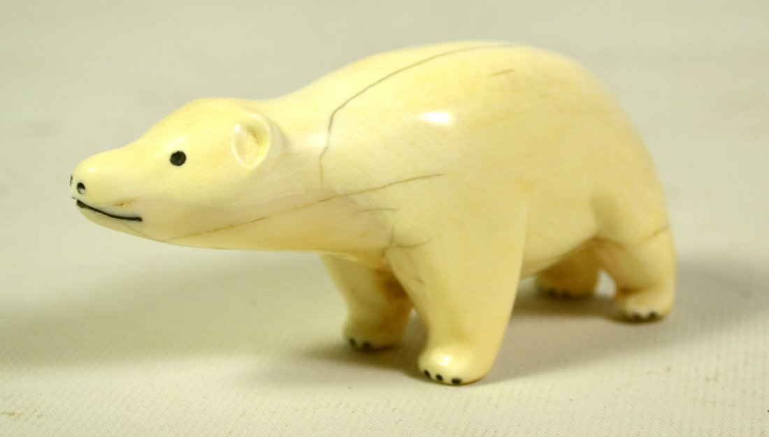Carving, Scrimshaw, Polar Bear, Eskimo: Carving, Scrimshaw, Polar Bear, Eskimo Polar bear carving. Age: 20th Century. Materials: Whale tooth. Construction: Carved. Region: Nothwest coast. Description: Depicts a polar bear. Size: 2"H x 4"W x