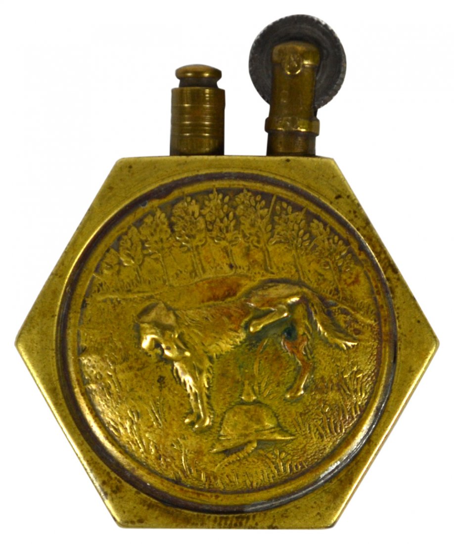 Lighter, WW1, Dog urinating on G. Picklehaube: Lighter, WW1, Dog urinating on G. Picklehaube Lighter Material: Machine metal, brass Construction: Assembled, screwed pinned. Marks: None Colors: Brass Features: Propaganda Trench Art WW1 lighter. Bra
