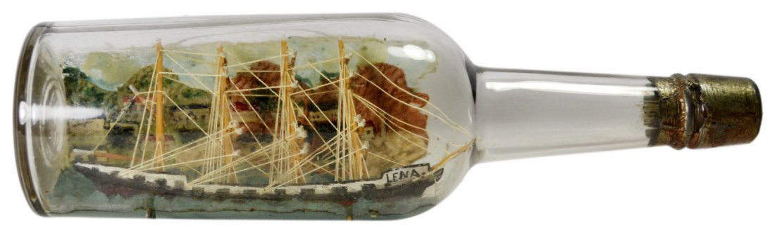 Ship in a bottle, Lena,c.1920: Ship in a bottle, Lena,c.1920 Ship in a bottle Material: Glass, wood, paint, cork, twine Maker & Markings: Sailor made ship in a bottle, hand painted on the starboard side is the ships name Lena. The