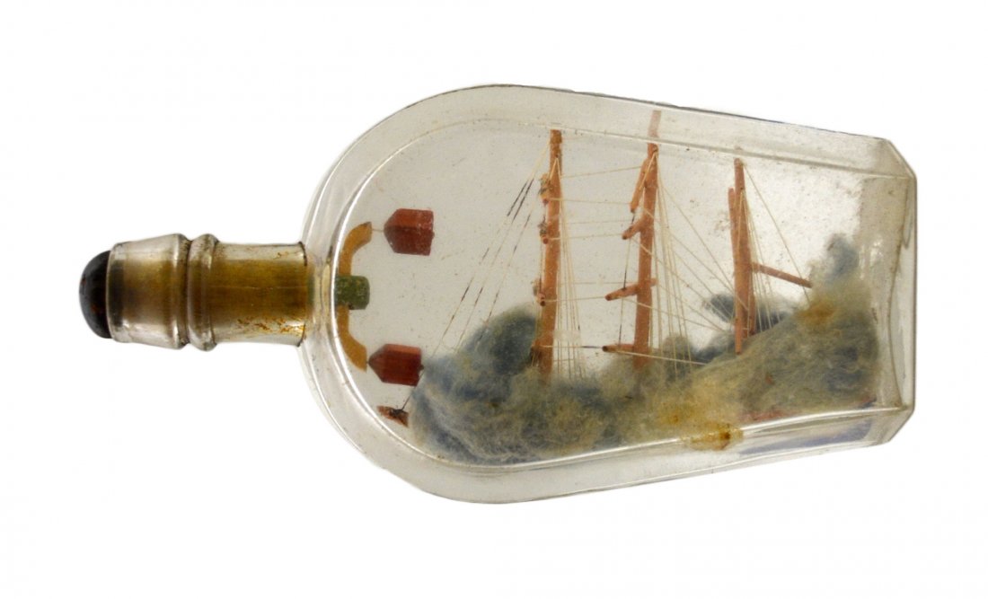 Ship In a Bottle, puzzle top, American flag c1900: Ship In a Bottle, puzzle top, American flag c1900 The Vessel Name: None Country of Origin: America Type: 3 masted, square rigged Hull: Red & blue Rigging: Better than average Deck Furniture: None Deco