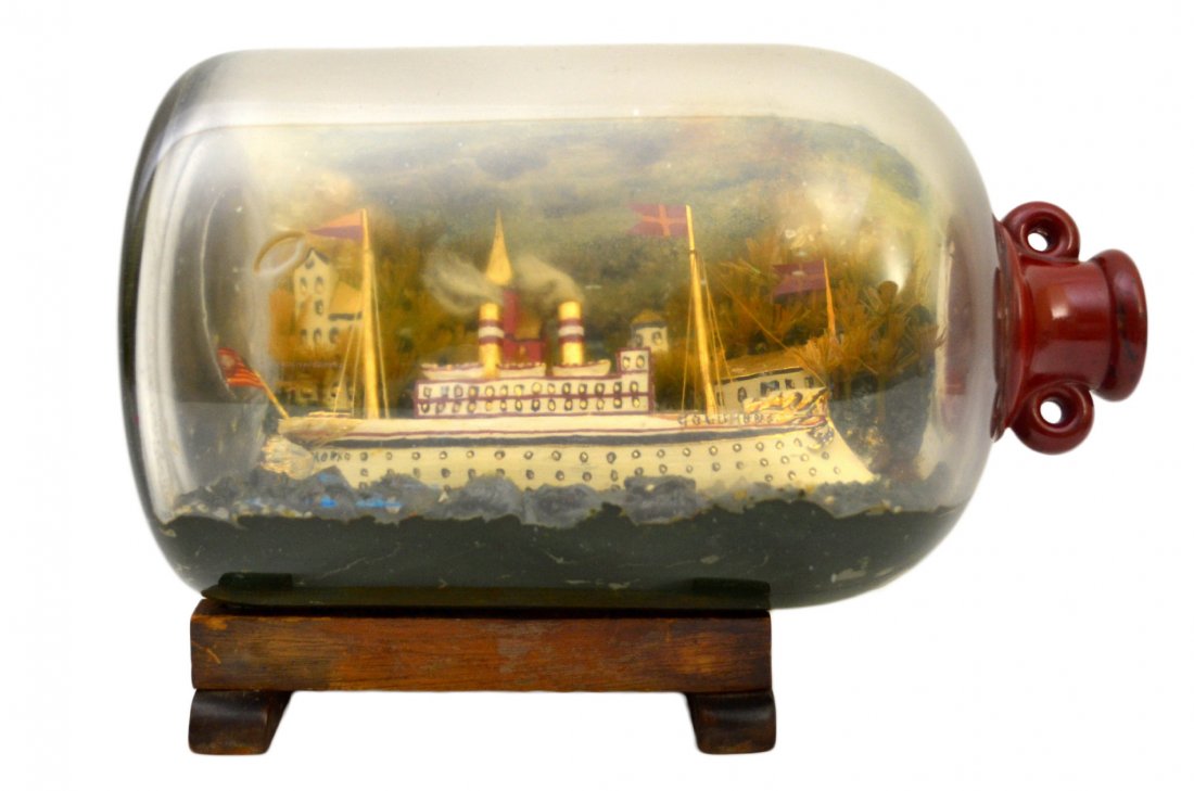 Ship In a Lrg Bottle, 'Columbus', c. 1910: Ship In a Lrg Bottle, 'Columbus', c. 1910 The Vessel Name: 'Columbus' Country of Origin: America Type: Steam Ship Hull: Red, white, blue, black Rigging: Two spar mast Deck Furniture: Life boats, 1st c