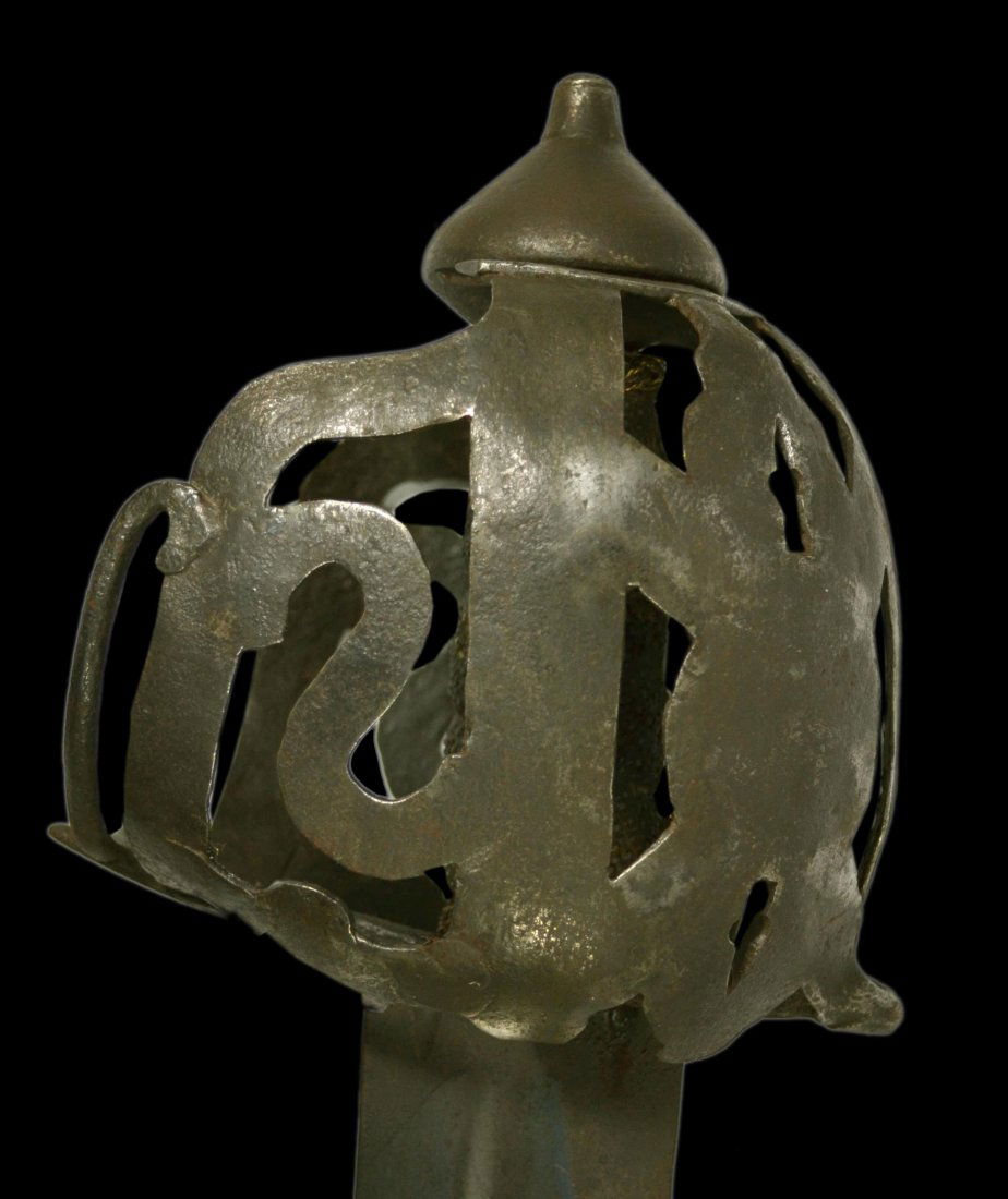 Sword, Scottish, basket hilt, c. 1725.: Sword, Scottish, basket hilt, c. 1725. Scottish basket hilt Material: Iron Construction: Hammered Marks: Non Features: Large rolled quillons, fretted and pierced pattern hilt, braided wire wrapped aro