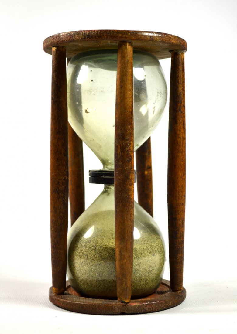 Sand timer, glass, birch, mahogany, 7", C. 1800: Sand timer, glass, birch, mahogany, 7", C. 1800 Form: Sand timer ,Hour glass Components: Wood, glass, sand Decoration: Carved wood end plates, Blown glass with 5 baluster shaped spindles. Date: Circa