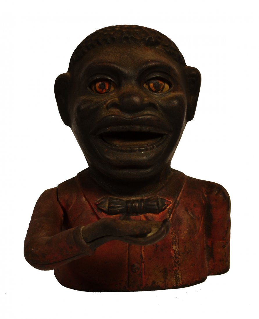 Bank, Cast Iron, "Jolly Nigger" 1882 J.E. Stevens: Bank, Cast Iron, "Jolly Nigger" 1882 J.E. Stevens Mechanical bank. Material: Painted cast iron. Construction: Cast. Marks: "Jolly Nigger Bank Pat. Mark 14' 82" Colors: Red. Features: The lever on the
