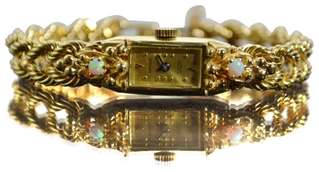 Watch, Cordova ladies, marked C"14k: Watch, Cordova ladies, marked C"14k Watch Description: Bracelet is double rope chain design. Dial and bracelet is gold. Face is set with two opals. Gold foldover style clasp and back of watch both mar