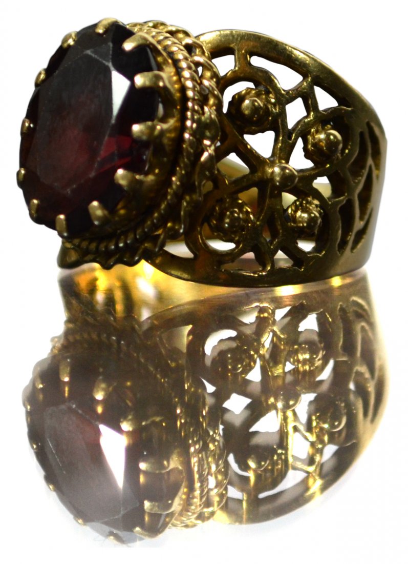 Ring, Ladie's 14k YG, garnet, c. 1940: Ring, Ladie's 14k YG, garnet, c. 1940 Ring Description: Set with one oval faceted garnet. Marked 'VN 14K' inside band. Material: 14k yellow gold Size: 1" x 3/4", Size 6.5 Weight: 6.9 dwt. Age: C. 1940