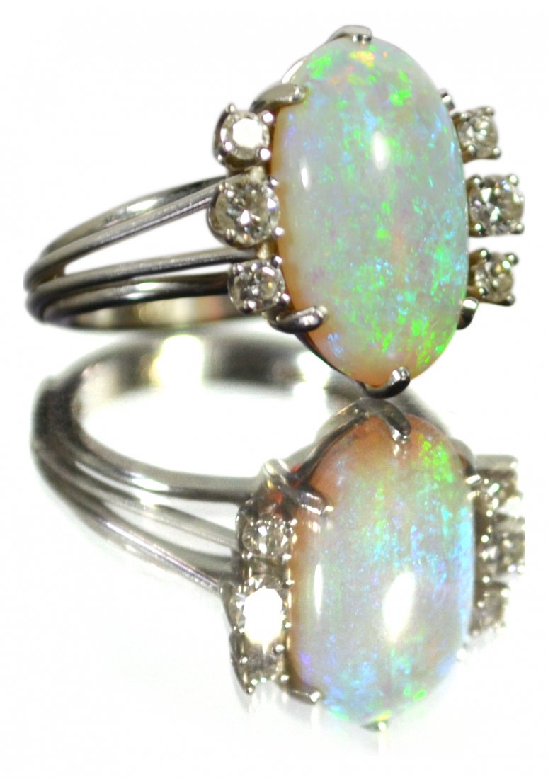 Ring, 18k white gold opal and diamond: Ring, 18k white gold opal and diamond Ring Description: Very fine opal. Marked 18. Material: 14k white gold Size: 5.5 Weight: 4.1 dwt. Age: 20th C Carat/stone Weight: .22 cts GH VS Condition: Very goo