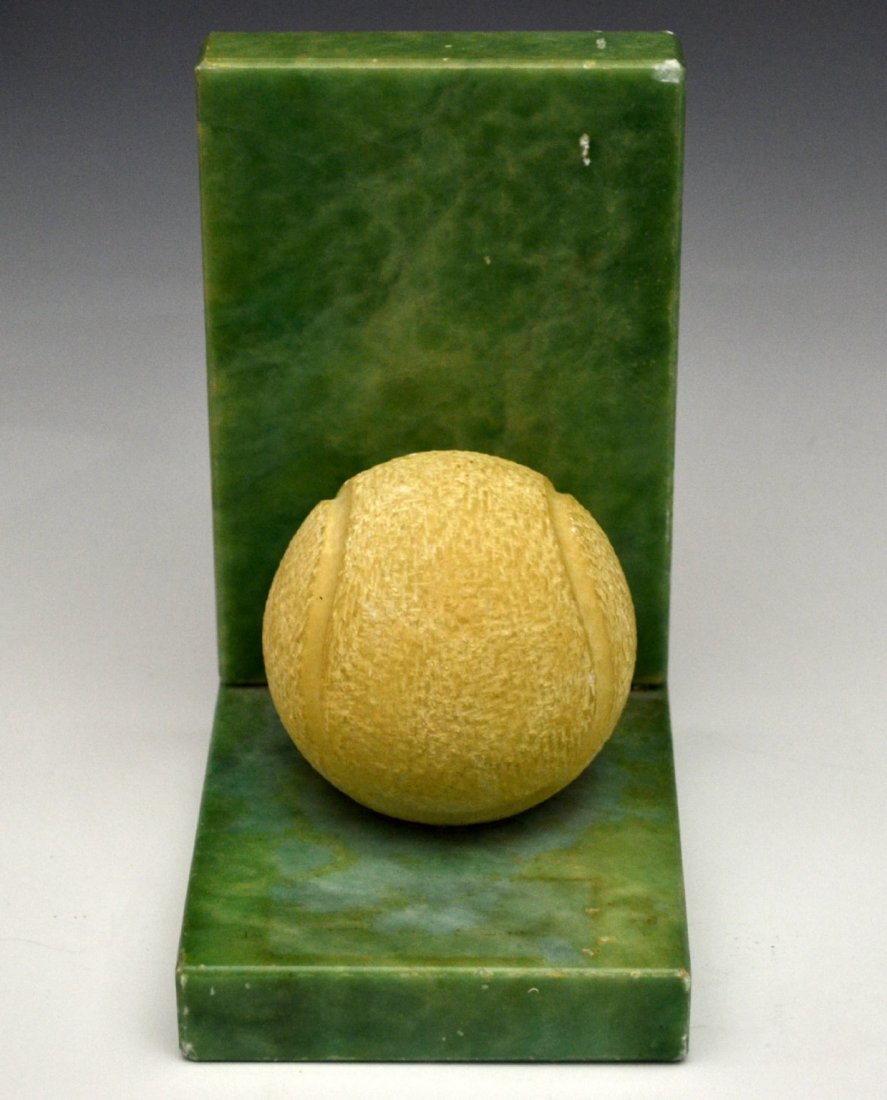Bookend, Carved Tennis Ball, Alabaster: Form: Bookend, tennis ball Material & Finish: Alabaster Construction: Carved Features: Depicts a tennis ball Maker & Markings: "57013 Made in Italy" Size: 6"H x 3.5"W x 4.75" D Weight: 3 lbs Condition
