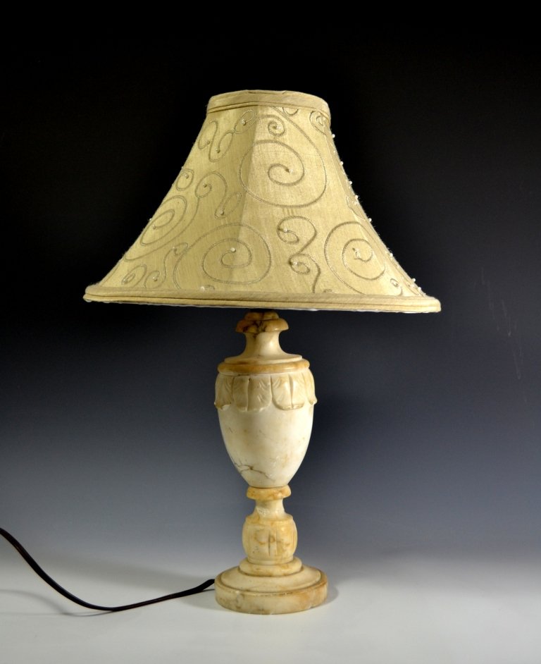 Lamp, Small, Alabaster: Small alabaster lamp Age: Early 20th Century Description: Carved leaf-like decoration wraps around lamp. Size: 17" H x 3.5" W Weight: 4 lbs Condition: Good. Minor chips. Meta: antique lamp, floor lamp