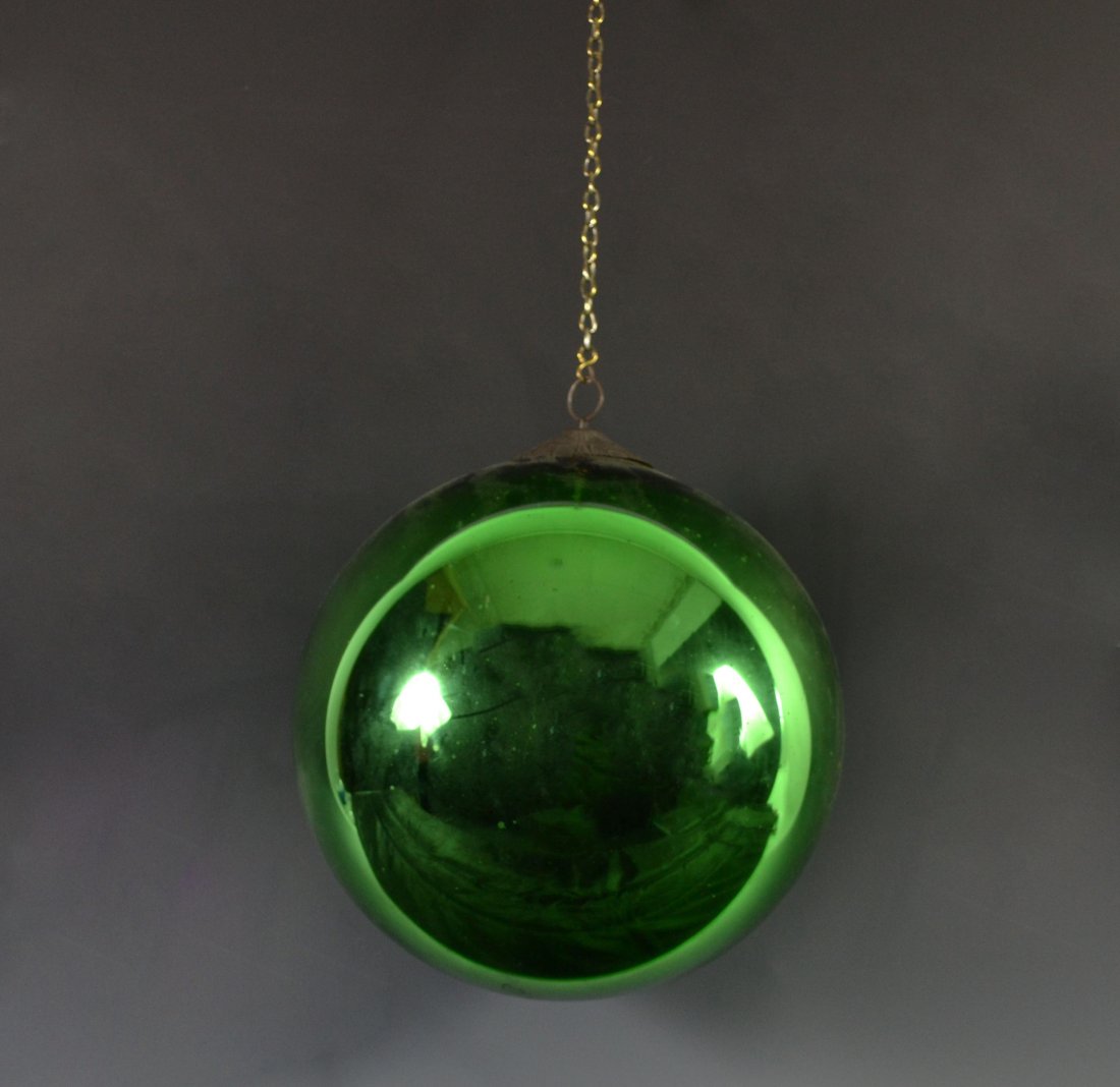 Green Witches Glass Ball w/ Hook: Form: Sphere Components: Glass Decoration: Green glass witches ball. Has hook designed in geometric patterns. Date: 20th Century Size: 11" D Weight: 1.9lb Condition: minor scratches. Meta: Glass