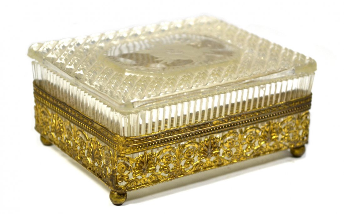 Crystal Box with Brass: Form: Box Components: Glass and Brass Decoration: Brass at bottom has floral pattern. Top cover floral design on glass. Construction: Rectangular cut shaped crystal box with brass fittings Date: 20th 