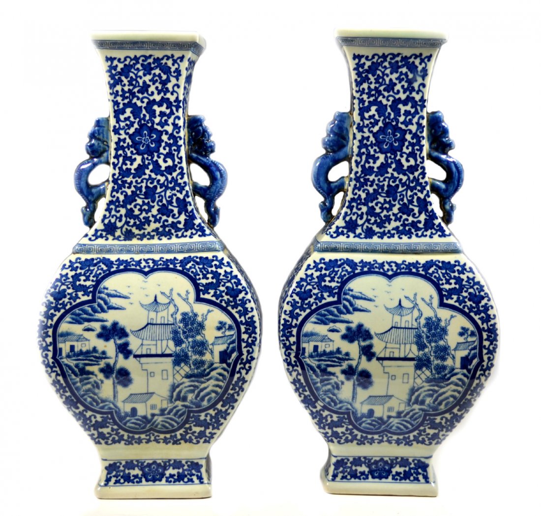 Pair of Chinese Vases, Kangxi: Form: Pair of vases Components: Hard paste Decoration: Vases have scroll and floral decoration with dragon handles. Scenes depict pagodas with trees. Colors: Blue & White Markings: Kangxi Reign Mark S