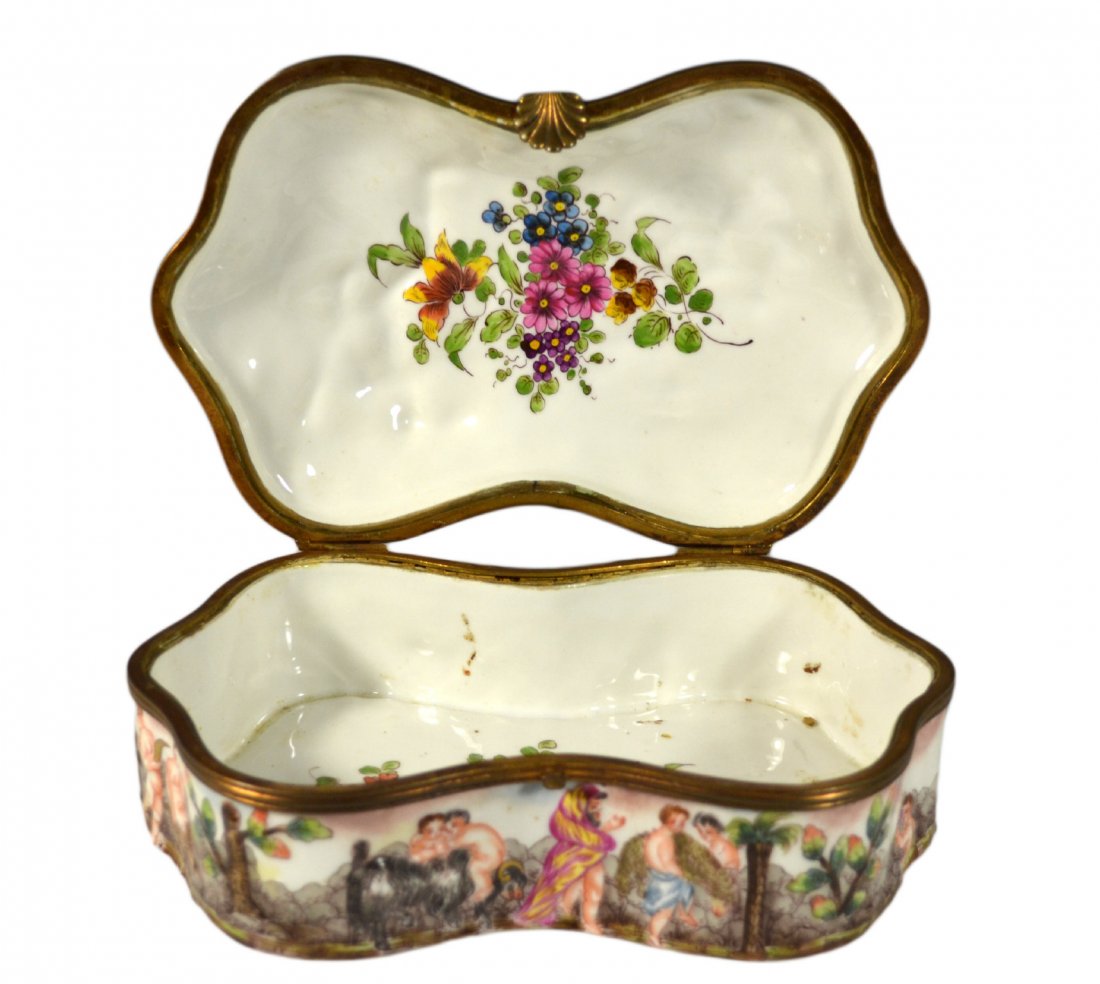 French Capodimonte Jewelry Casket: Form: Hinged Box Components: Porcelain Decoration: Capodimonte Table Casket with a classical scene in relief. Interior floral design. Inscribed N and crown shape with signature that reads B. Gutlman &