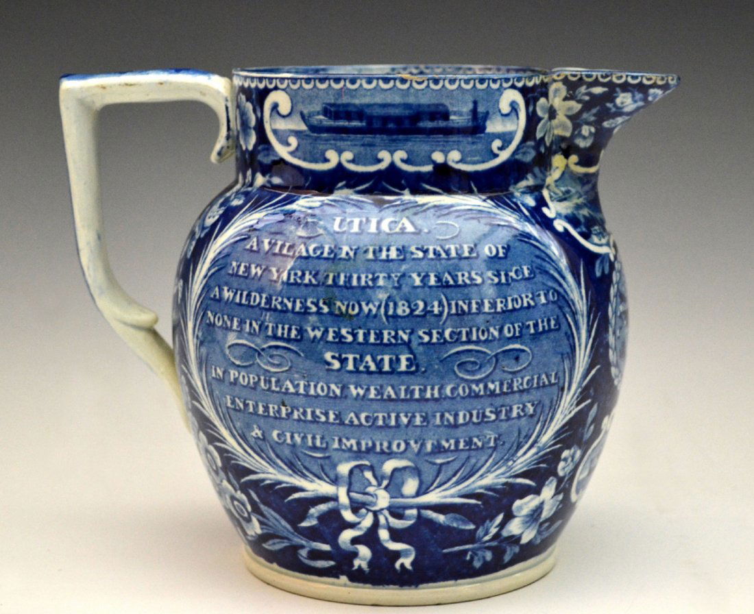 Pitcher, Blue Staffordshire, Grand Erie Canal: Pitcher Material: Pearlware Marks: None Colors: Blue Features: Dark Blue Staffordshire Pitcher, Grand Erie Canal, with four small vignette scenes of the canal and boats on rim and front, spread winged