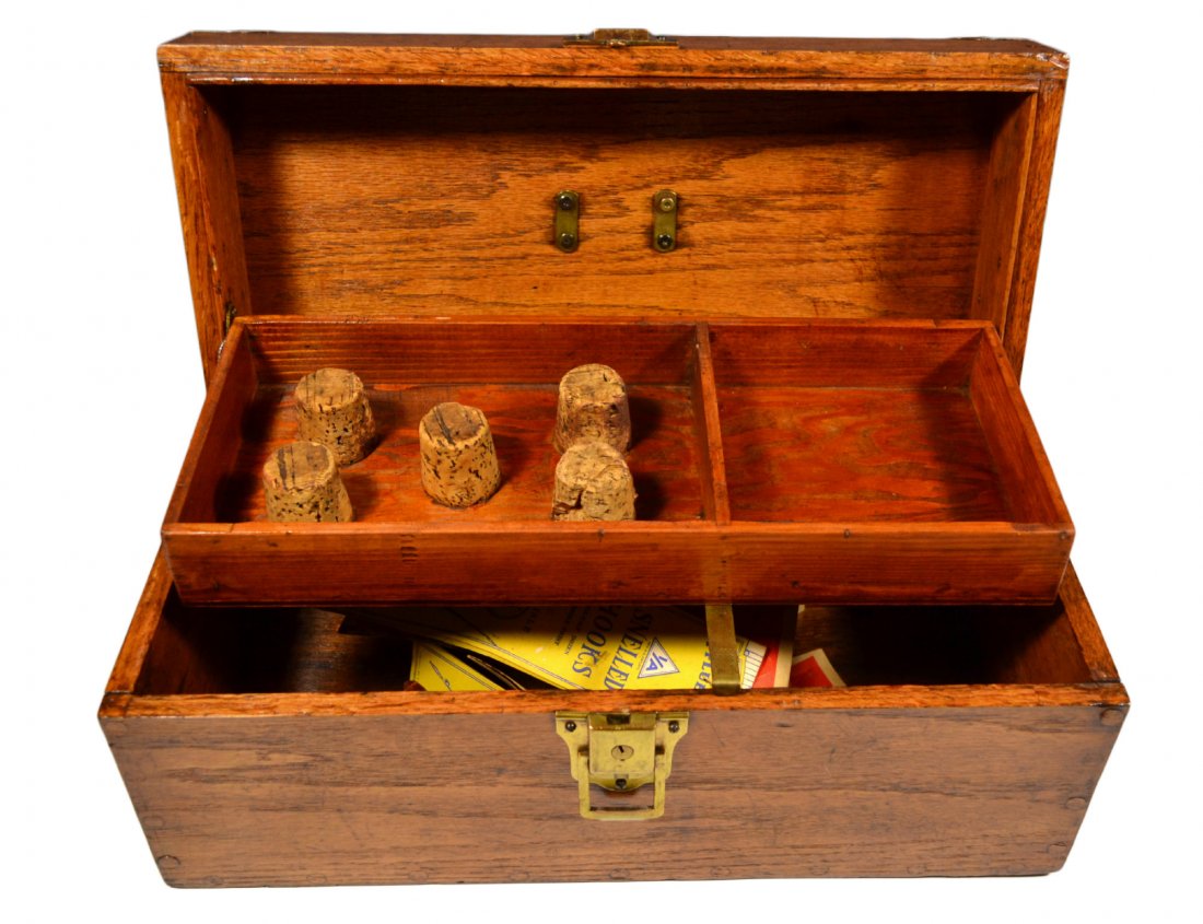 Fishing Tackle Box, Circa 1900: Tackle box Material: Wood and brass Construction: Wood pegs Marks: None Features: 55 wood pegs hold the box together. Brass escutcheon on front, brass handle, and four brass corner covers. Inside the 