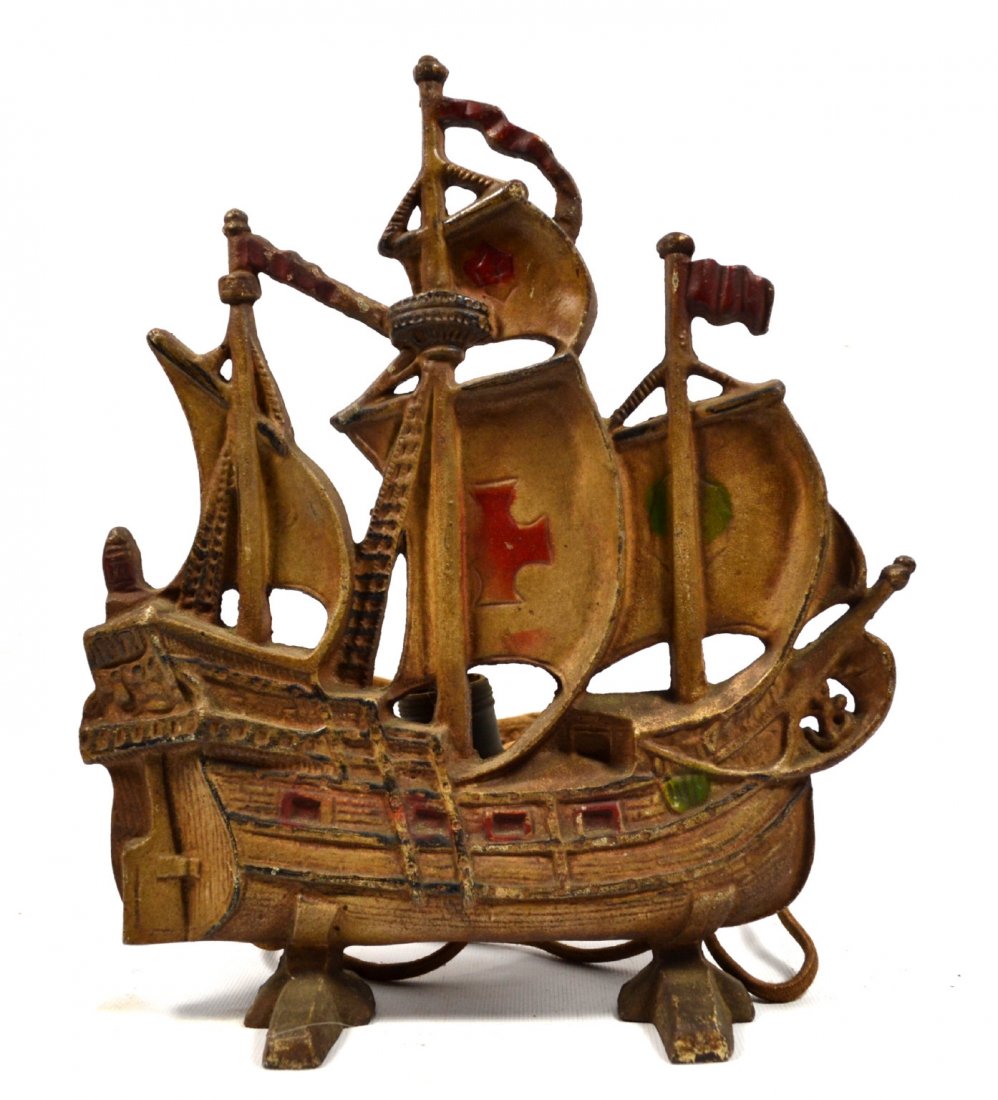 Doorstop w/ original lamp Ship Santa Maria: Doorstop and Lamp Material: Painted Cast Iron Description: Electrified lamp depicts the three masted ship Santa Maria, Columbus's flag ship. The back is marked "A 13." Construction: Cast Date:c. 1925