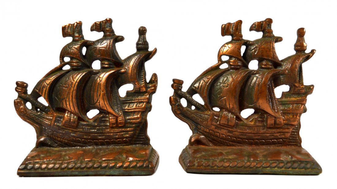 Pair of Bookends, Ship, 20th Century: Bookends Pair of Bookends Form: Ship Construction: Cast Features: Cross and Sun on sails, 3 Masted Maker & Markings: Santa Maria K. Size: 5" L x 5.5" W x 2" D Weight: 3.5b Condition: Light wear Meta: