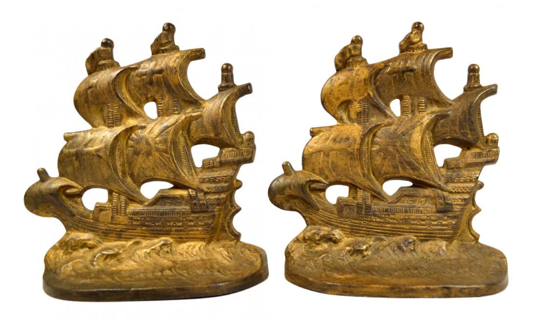 Pair of Bookends, Spanish Galleon, 1928: Bookends Pair of Bookends Form: Galleon Material & Finish: Cast Iron, Golden finish Construction: Cast Features: 3 Masted, Cross and Sun on sails Maker & Markings: On back "Spanish Galleon, COPR 1928"