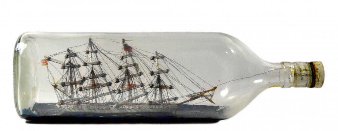 Ship In Bottle, Schooner, "Sea Prince" c. 1940: Ship in bottle Name: Sea Prince Country of Origin: Great Britain Type: Schooner Hull: Painted white Rigging: Standing rigging Deck Furniture: White covered hatches Decoration: Ship in bottle is decora