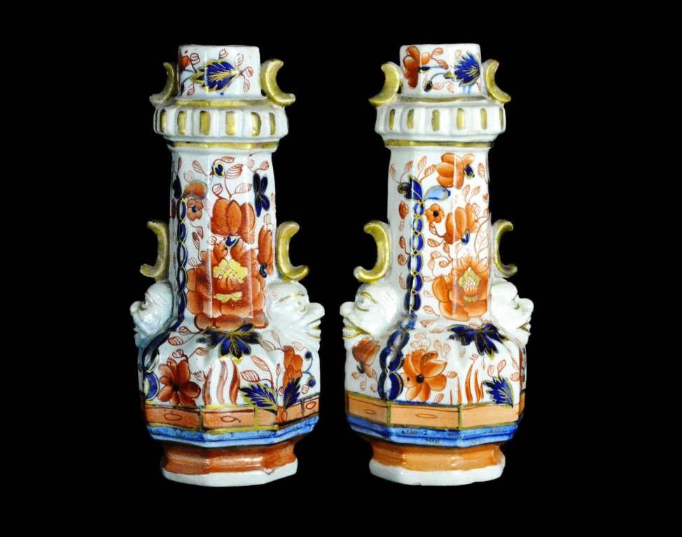 2 Vases, Mason Ironstone, C. 1820: Form: Vases Components: Hard Paste Decoration: Pieces have been hand painted in floral patterns. Glazed and gilded. Detail on side resembles a face. On base "China Ironstone" Colors: White, Blue, Red 
