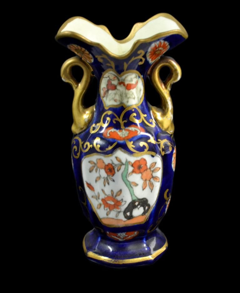 Vase, Miniature Mason Ironstone, c.1820: Form: Vase Components: Hard Paste Decoration: Flower pattern throughout vase. Glazed and gilded. Handles resemble shape of golden swans. Colors: Gold, Blue, White Markings: None Date: c. 1820 Provenan
