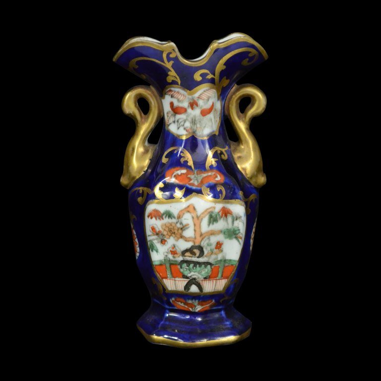 Vase, Miniature, Mason Ironstone, c.1820: Form: Miniature Vase Components: Hard Paste Decoration: Flower pattern throughout vase. Glazed and gilded. Handles resemble shape of golden swans. Colors: Blue, White, Gold Markings: None Date: c.1820