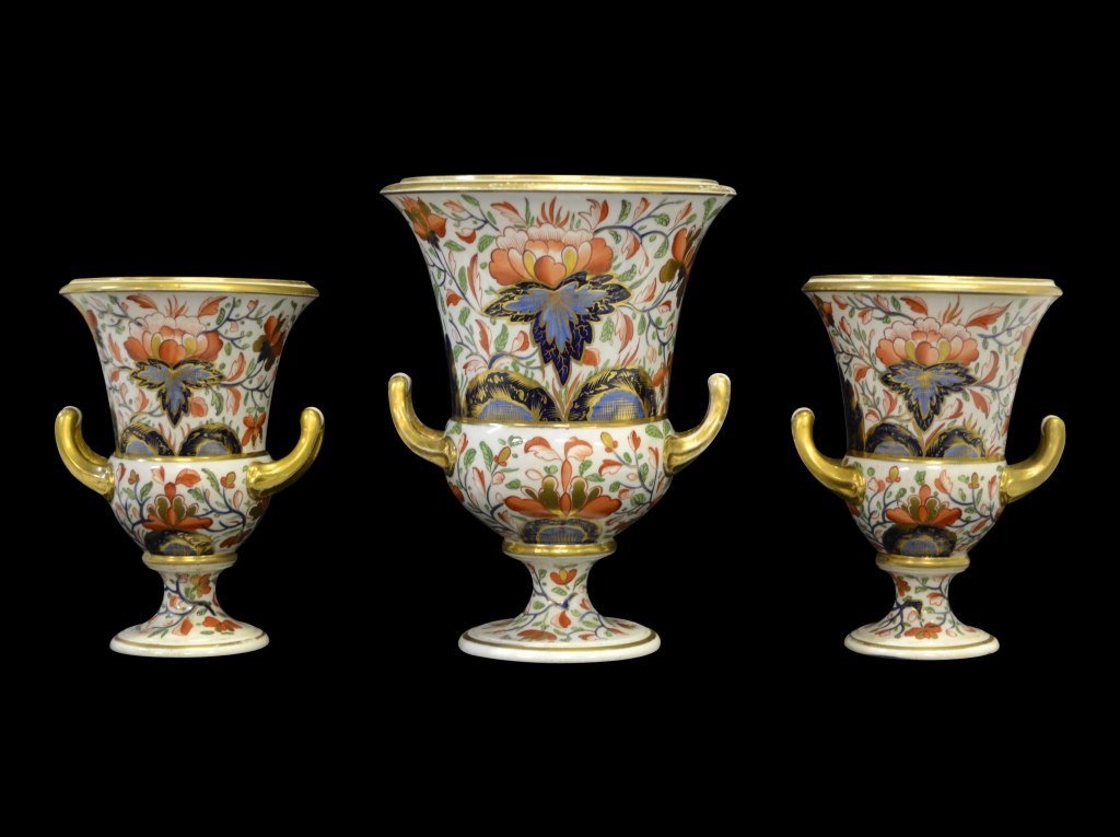 3 pc Garniture Set, Derby, c. 1806-1825: Form: Garniture Set Components: Hard Paste Decoration: Old Imari pattern, hand painted, glazed and gilded. On bottom: Painted mark with Crown and D. Colors: White, Blue, Red, Gold Markings: Derby Date
