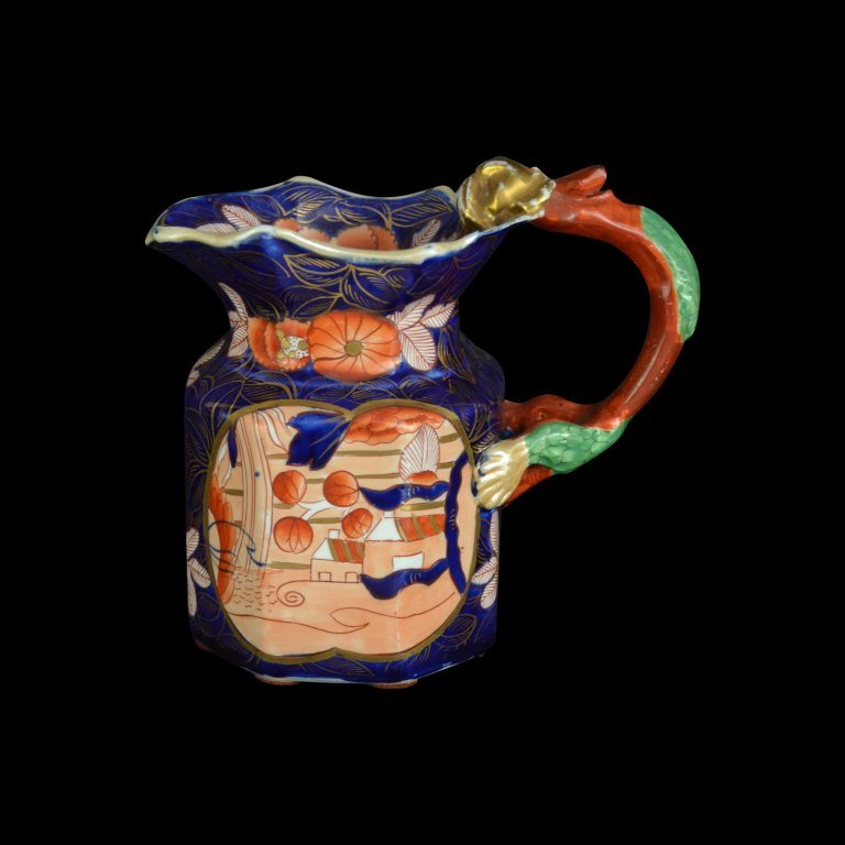Jug, Mason Ironstone, C. 1820: Form: Jug Components: Hard Paste Decoration: Floral pattern, hand painted, gilded and glazed. Handle is shaped in dragon form. Colors: Blue, Red, Green, Gold Markings: on bottom Date: c. 1820 Provenan