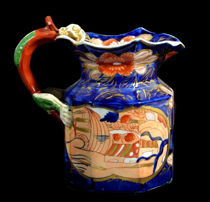 Jug, Mason Ironstone Schoolhouse, C. 1820: Form: Jug Components: Hard Paste Decoration: Floral pattern, hand painted, gilded. Handle resembles dragon. Colors: Blue, Green, Gold Markings: Mason Ironstone Date: c. 1820 Provenance: The estate of 