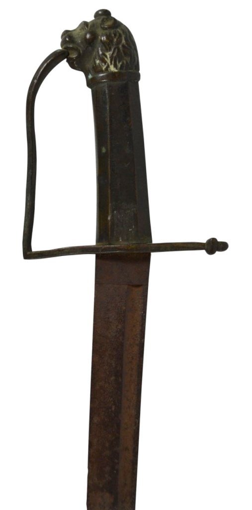 Sword, Hanger, Lion Head Pomell, c. 1770: Sword Material: Iron Construction: Forged Marks: None Features: Sword has a D shape knuckle guard with a lion's head pommel cap and eight sided iron grip. Blade (0.2"W thickest). Fuller is 21"L x 0.4"