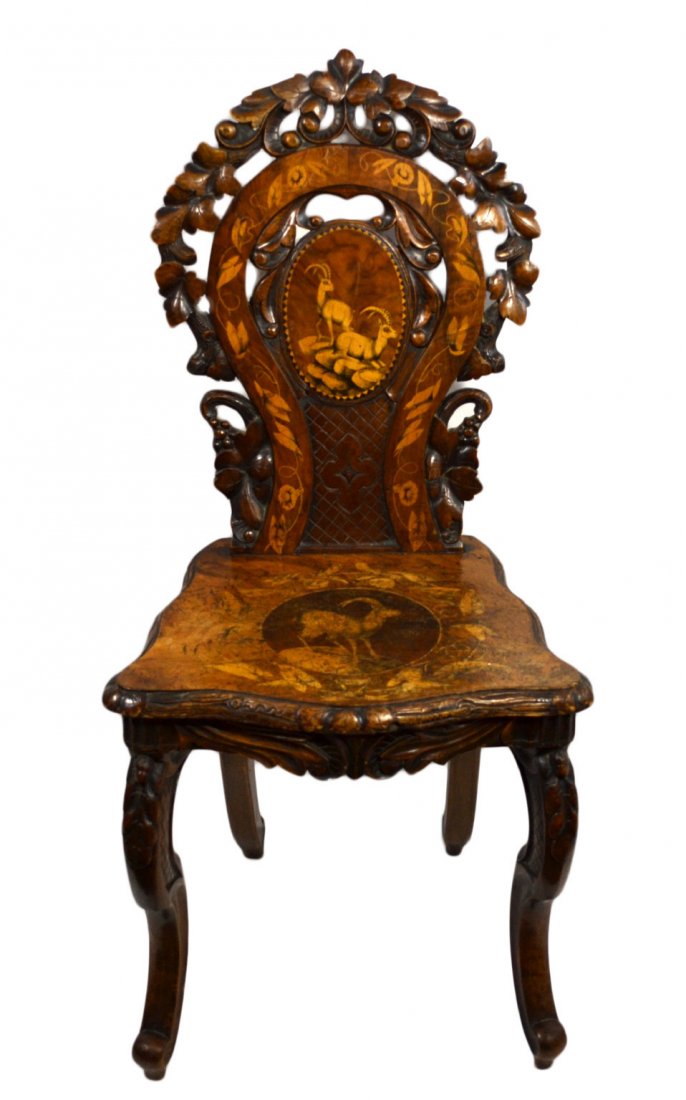 Chair, Marquetry, Carved Black Forest, Inlaid: Chair Wood: Walnut Secondary Wood: Inlaid contrasting color. Joinery: Mortise and tenon Features: Swiss carved chair with a shaped openwork backrest and hinged plank seat. Depicts male Alpine Ibex. Da