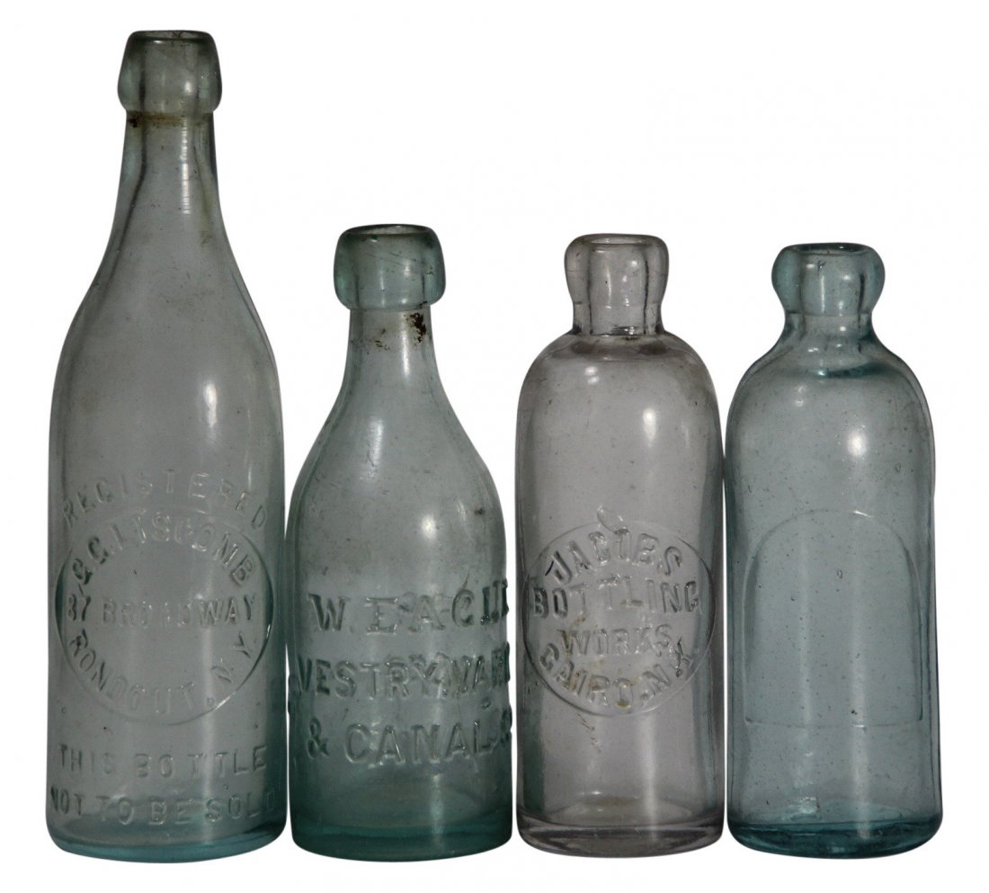 (4) Glass Bottles, Rondout, Cairo,NY- Phila., PA.: Form: Glass bottles, soda water Components: Glass Decoration: These cylindrical bottles all have Hutchinson stoppers at their tops. Three of the four are aqua in color, while the last, the bottle from
