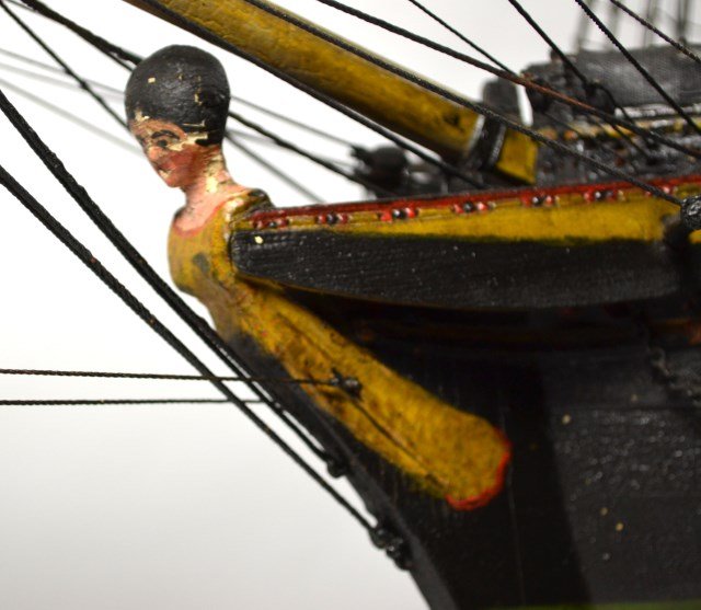 Model naval brig, original paint, c. 1820: Ship model Materials: Wood, hemp, paint Construction: Carved, painted Date: C. 1820 Description: Description: Model of an 18-Gun Naval Brig on its original cradle type stand. Standing rigging is tarre