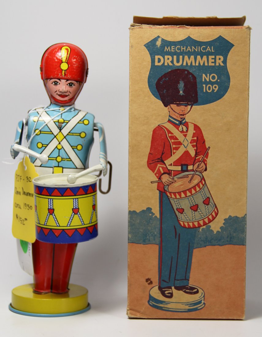 Toy Chein Drummer w/ Original Box, 1950s: Tin Drummer Maker: J. Chein Materials: Tin Construction: Tinplating Labels/Tags: J. Chein Age: 1950 Description: This tin drummer is blue, red, yellow, and white. Comes in original box. Size: H. 8.75x