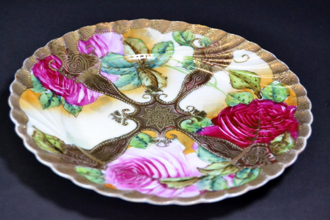 Plate, Japanese porcelain, circa 1890: Description: A porcelain plate, floral pattern that is hand painted with gilding and raised gilt work, Japanese characters on the bottom. Material: Porcelain Maker/Artist: Japanese school Date: Circa 