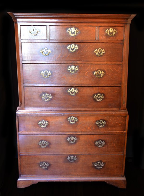 Chest on chest, c. 1790: Description: Constructed of oak with pine backboards, chamfered upper case sides and bracket feet. Original brasses and fine cut dovetail joinery. Material: Oak, Pine Maker/Artist: Unknown Date: Circa