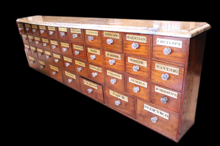 Apothecary, by C.B.S. Circa 1860: Description: Each of the 40 drawers has the original, faceted pressed glass pull and reverse painted labels in black on a gilt backing, all labels under glass. Each glass has a bevel cut perimeter. Co
