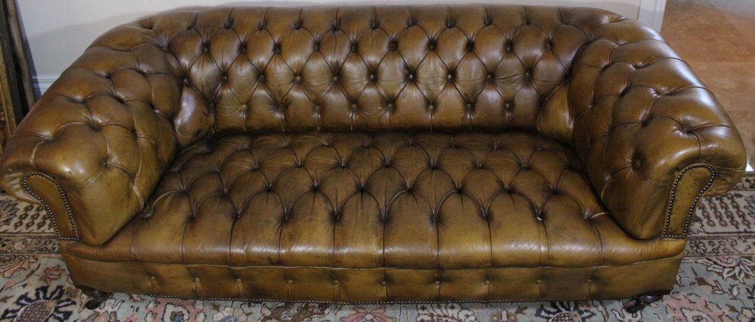 Couch, Leather, Carved, Turned Legs, . 1830: Description: An antique leather couch, light colored brown,c. 1830. Two front turned legs, terminating in gilt brass hardware, rear legs carved and splayed with all resting on ebonized mahogany caster