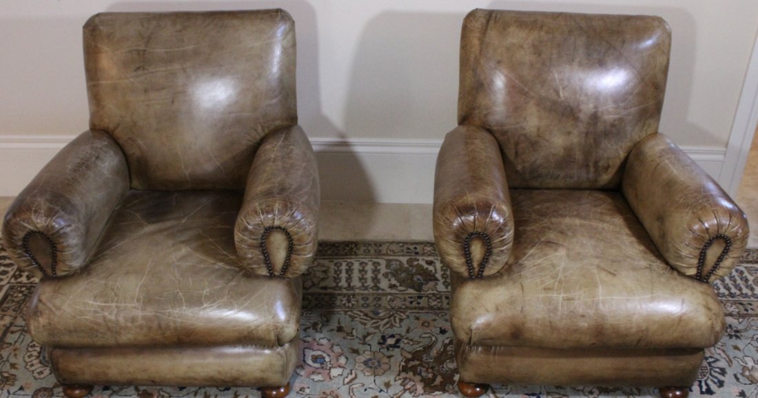 Pair Club Chairs, Reproductions: Description: Dyed leather fastened with brass backs resting on turned bun feet. Material: Leather and Brass Maker/Artist: Unknown Date: Recent Provenance: Whitenack estate of Naples, Florida