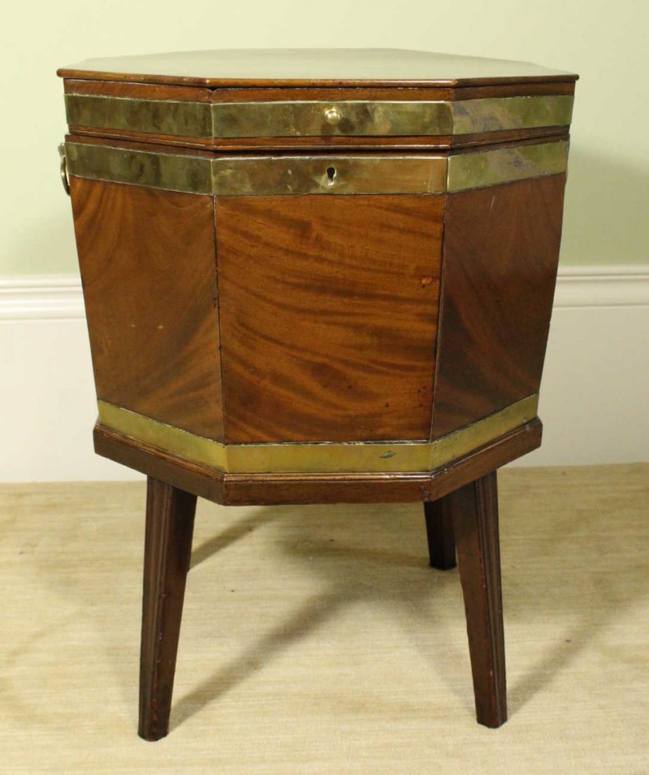 Cellarette, c. 1850: Description: Constructed of mahogany solids with brass banding and side handles. Splayed legs are tapered with beaded edges. Interior has removable half shelf, later satin interior lining. Material: M