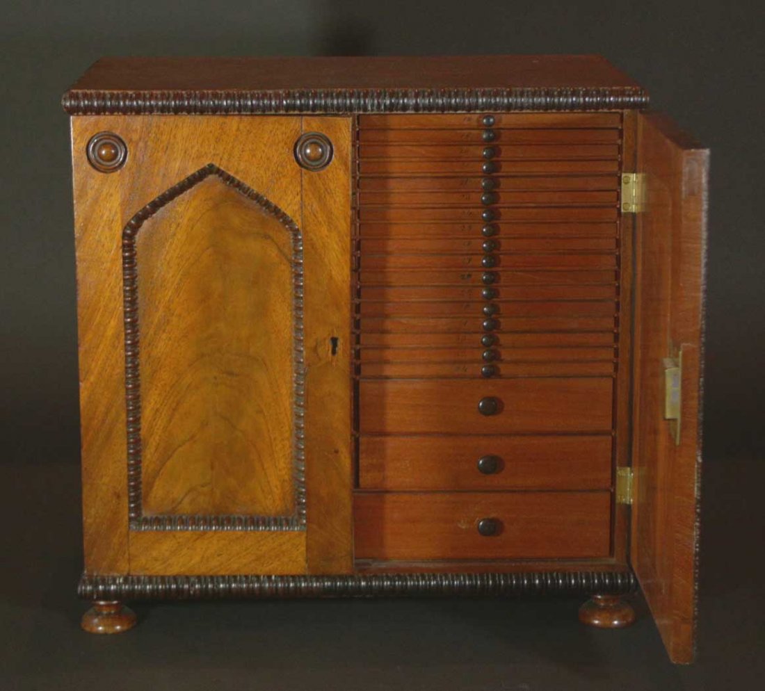 Collectors Or Watch Makers Cabinet: Description: 39 drawer cabinet, each of the narrow drawers having specific diameter holes drilled & hand numbered. Woods are walnut & mahogany with turned ebony pulls, applied spool moldings, England,