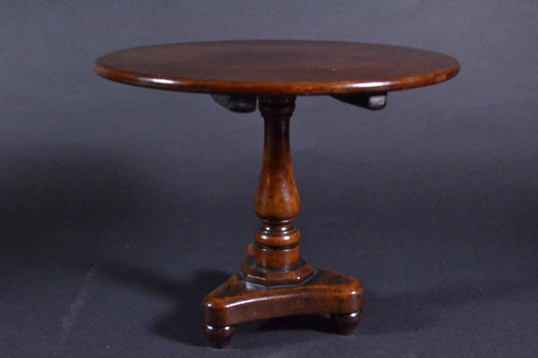 Table, Miniature, Tilt-Top, Regency, c. 1840: Description: Constructed of mahogany and having turned ball feet and batten across the bottom of the top. Nicely constructed period piece having a lead seal on bottom. Material: Mahogany Maker/Artist: