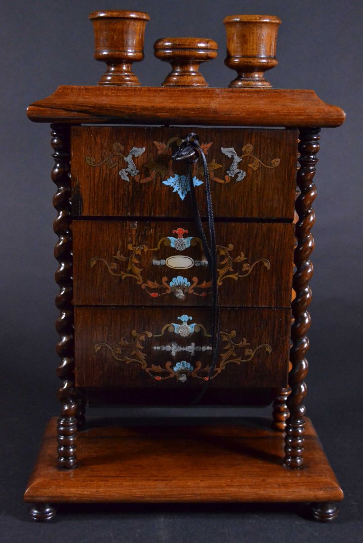 Mechanical box, c.1860: Description: Unique design, when key is turned drawer fronts drop down for access, rosewood & mahogany with ivory pin caps. Drawer fronts are inlaid with brass, silver, copper, mother of pearl, red co