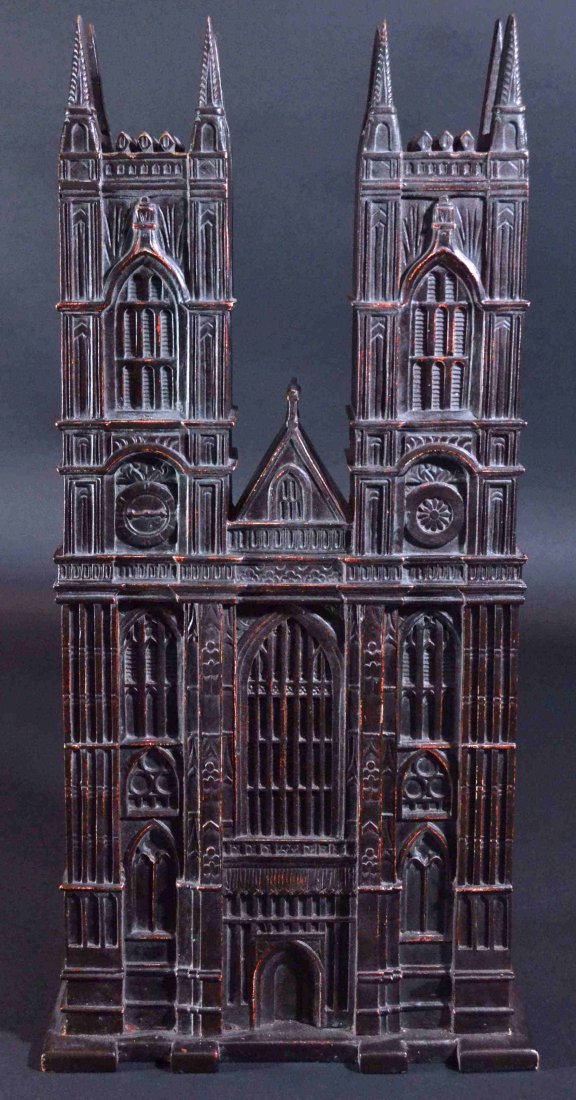 Gothic facade, 19th century: Description: Carved hardwood intricately detailed to replicate a Gothic facade. Two towers with spires, one having a clock face, the second one with a rosette. Large window in the center with gable ro