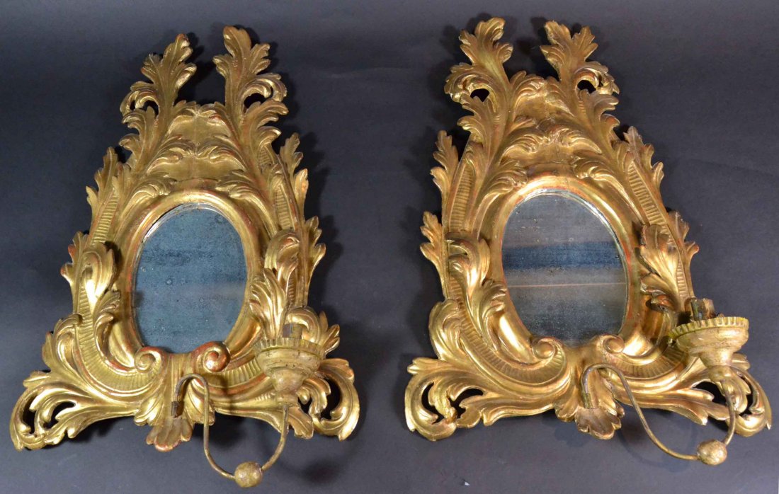 Pair mirrored sconces, 20th Century: Description: Hand carved pine, gilded with single candle holders and having old glasses. Material: Pine, Glass. Maker/Artist: Unknown Date: 19h Century Provenance: Whitenack estate, Naples, FL