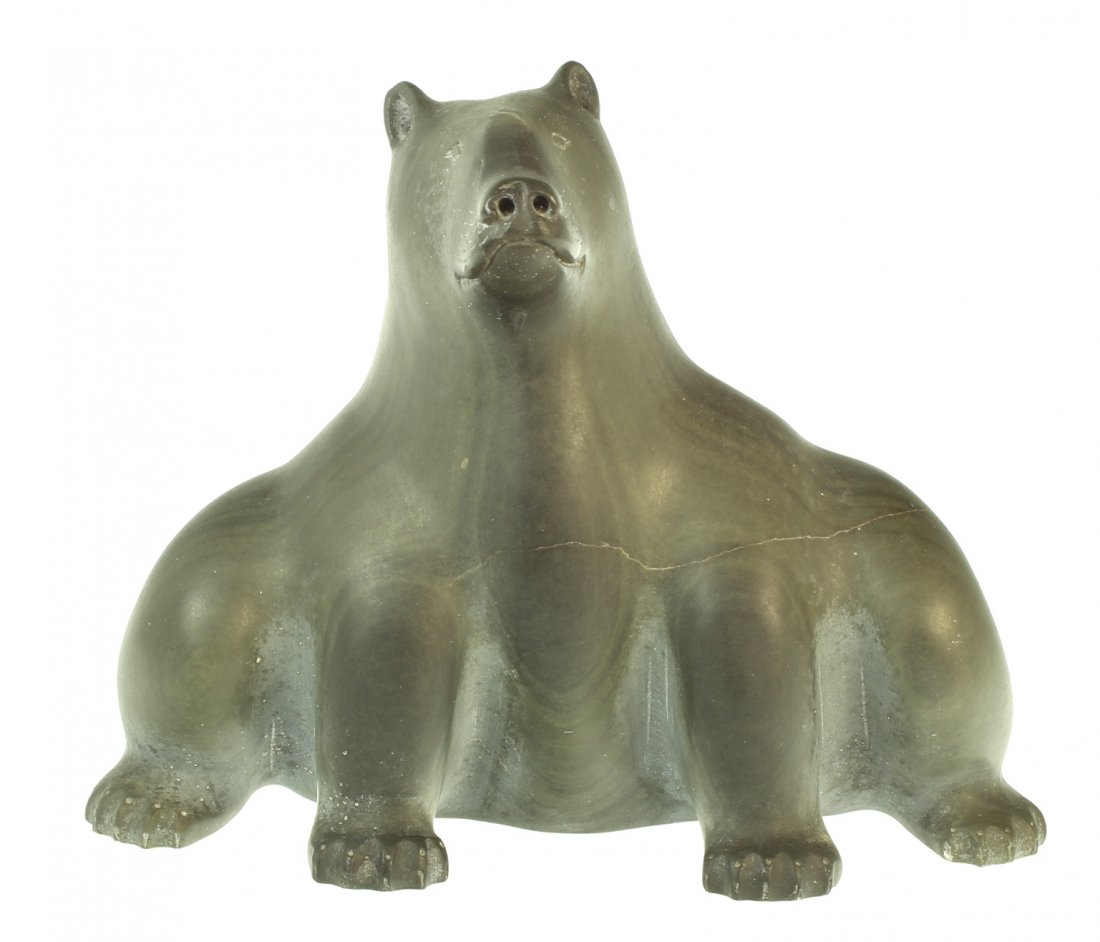 Inuit stone carving of bear: Description: Inuit carved stone bear sitting at attention on his hind legs, has writing on the bottom, smooth dark greenish color. Material: Stone Maker/Artist: Inuit school Date: Late 20th century Pr
