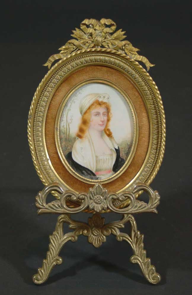 Miniature on ivory, Signed. Circa 1820: Description: Portrait of a woman in a landscape signed (Jean) Derval and titled in pen verso Miss Tighe. Together with a brass easel for display, French, c. 1820. Material: Ivory Maker/Artist: Derval