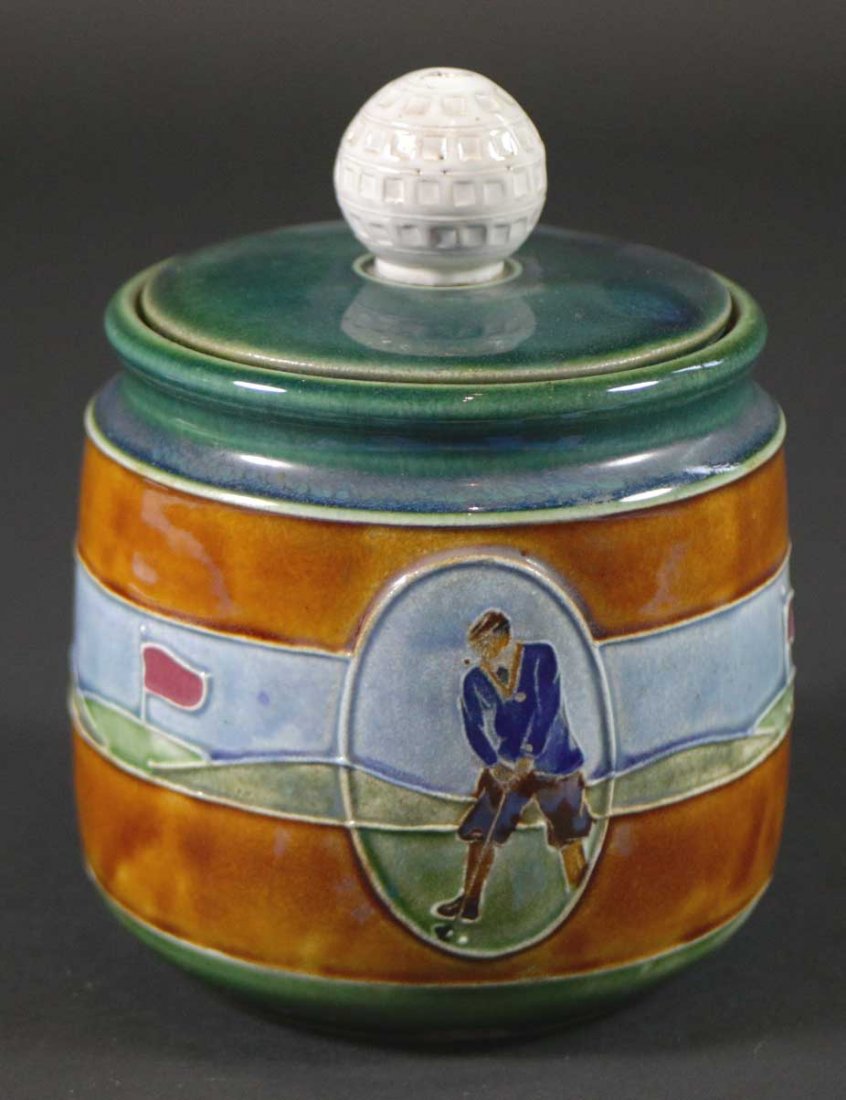 Golf Jar w/Golf Ball Lid, Marked Clifton: Description: A jar with lid in a golf theme, has an interlocking lid. The lid has a golf ball on it. Material: Porcelain Maker/Artist: Clifton Date: Circa 1900 Provenance: n/a Size of Artwork