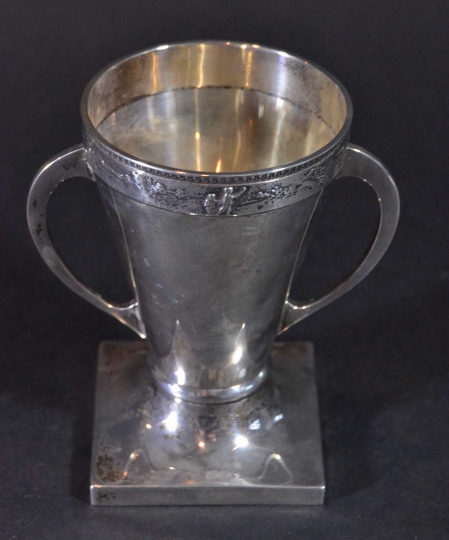 Golf Trophy Loving Cup, Hallmarked: Description: A golf trophy, the rim has a raised scene of golfers. Material: Silver plate Maker/Artist: Unknown Date: Circa 1900 Provenance: n/a Size of Artwork: H 4 x W. 4 x D. 2 in <